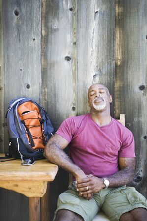 Male hiker resting with backpack