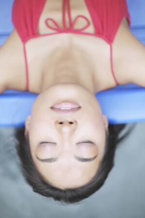Overhead view of a relaxed young womanの写真素材