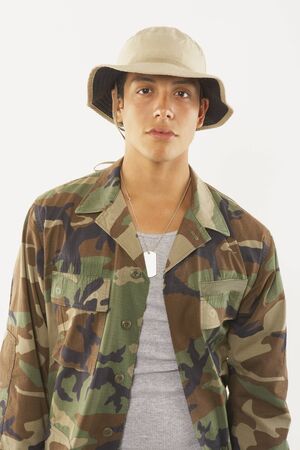 Portrait of young male soldier in fatiguesの写真素材