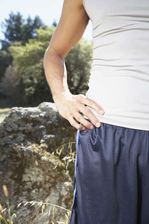 Man standing with hands on his hips