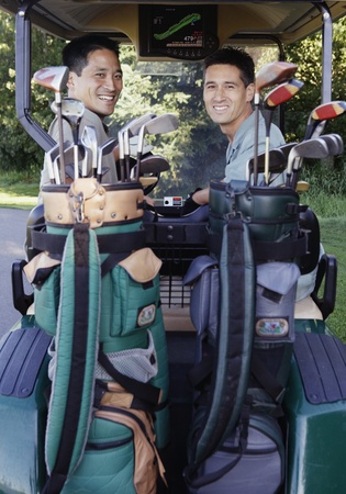 Two men in golf cartの写真素材