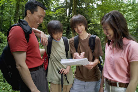 Family checking map while hikingの写真素材