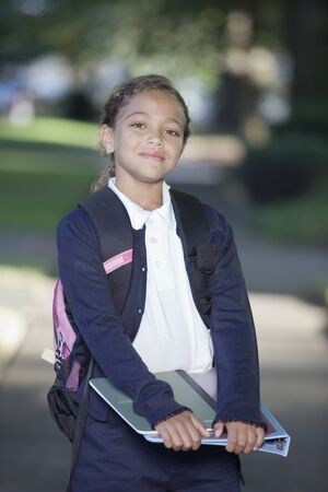 Portrait of girl holding school booksの写真素材
