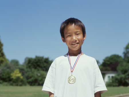 Portrait of boy with metal around neckの写真素材