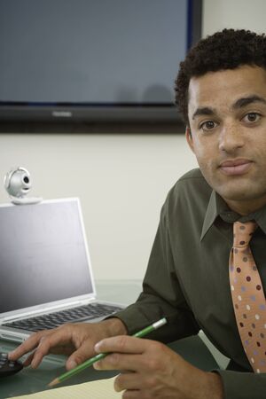 Young office worker at deskの写真素材