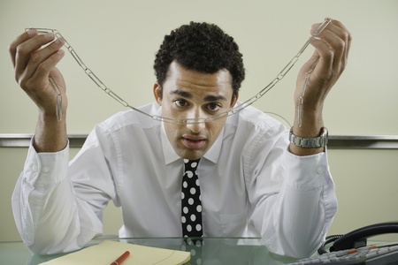 Businessman staring at paperclip chainの写真素材