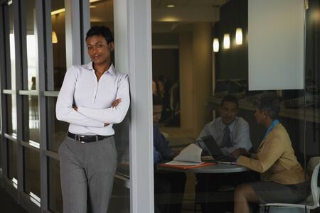 Smiling woman with colleagues in background