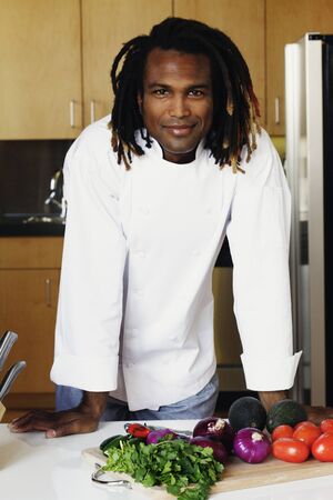 Portrait of male chef standing in kitchenの写真素材