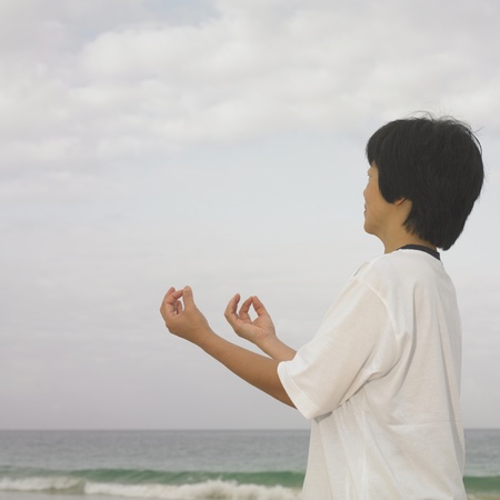 Woman meditating at beach