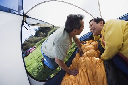Couple kissing in tentの写真素材