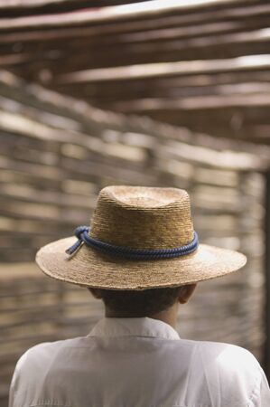 Rear view portrait of man wearing straw hatの写真素材