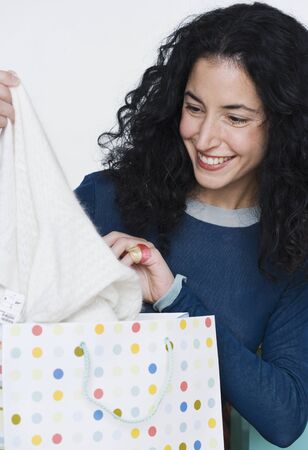 Young woman admiring new purchaseの写真素材