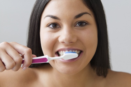 Young woman brushing her teeth