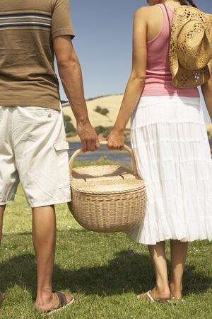 Couple holding a picnic basketの写真素材