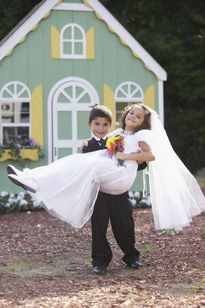 Boy and girl at pretend weddingの写真素材