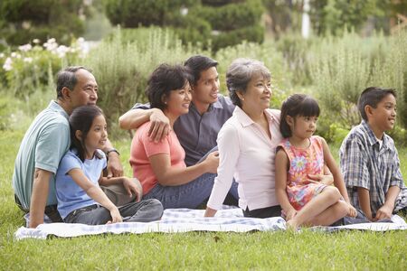 Family sitting on blanketの写真素材