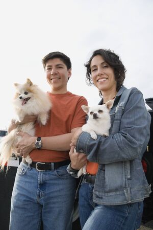 Couple holding their dogsの写真素材