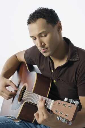 Young man strumming a guitar