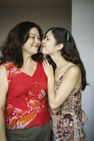 Mother and daughter kissingの写真素材