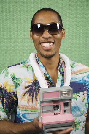 Young man taking a Polaroidの写真素材