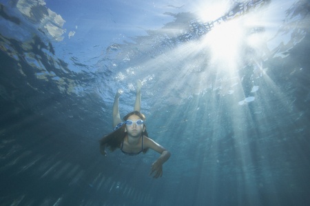 Young girl swimming in a poolの写真素材