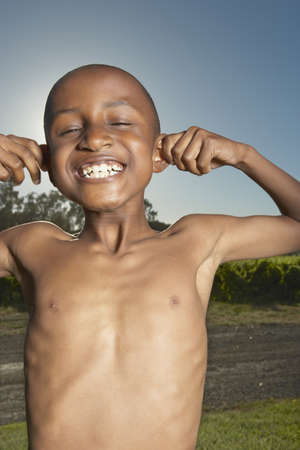 Young boy making a face for the cameraの写真素材