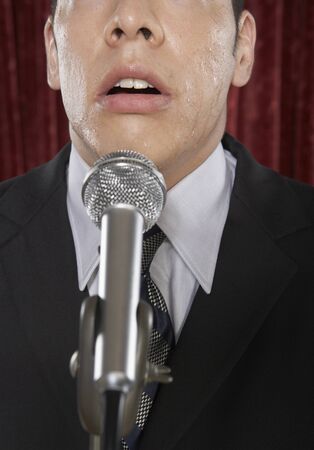 Man speaking into a microphoneの写真素材