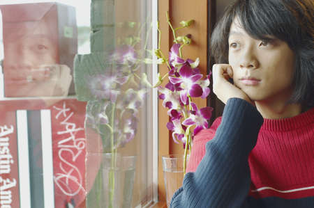 Young man looking out a window