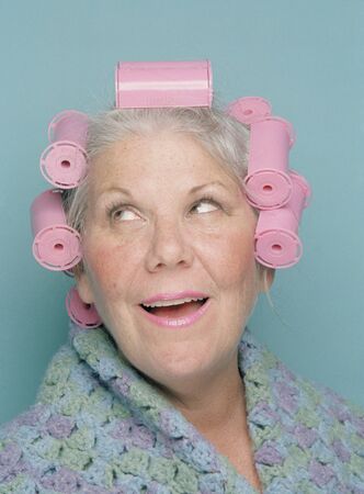 Senior woman wearing hair rollersの写真素材