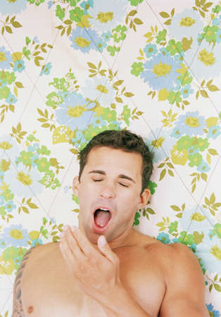 Young man yawningの写真素材