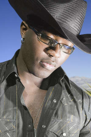 Young man in cowboy outfit posing for the camera