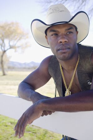 Young man in cowboy outfit posing for the cameraの写真素材