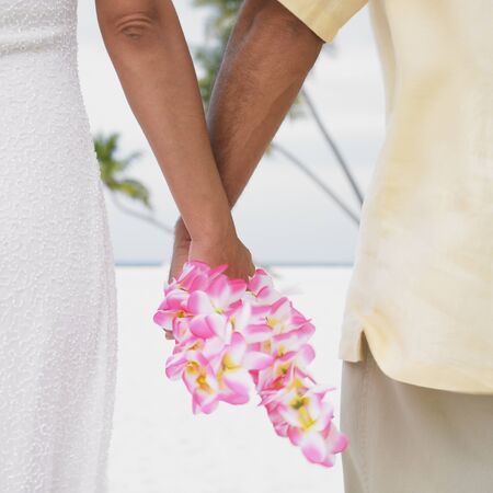 Couple holding hands on the beachの写真素材