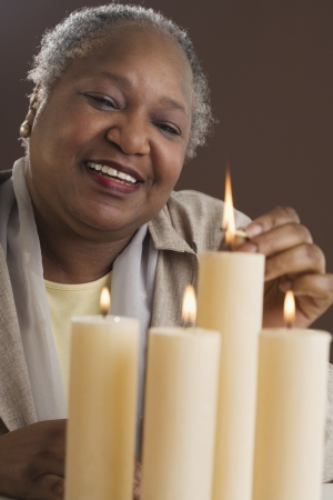 Senior woman lighting candlesの写真素材