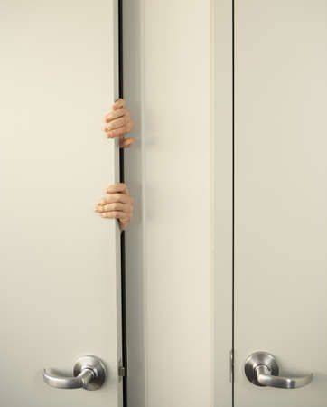 Businessperson clutching door-jamb