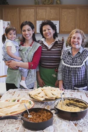 Female Hispanic family members smiling in the kitchenの写真素材