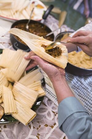 Hispanic woman preparing foodの写真素材