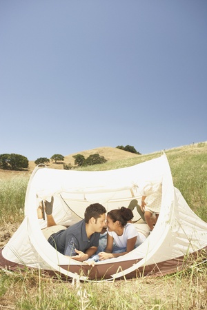 Couple kissing in a tentの写真素材