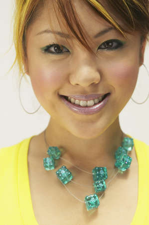 Young woman posing for the camera in dice jewellery
