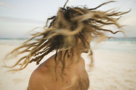 Young man shaking his dreadlocksの写真素材