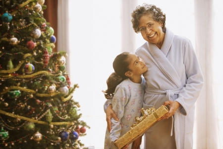 Hispanic grandmother and granddaughter on Christmas morningの写真素材