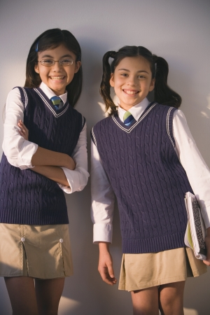 Two school girls in uniform smilingの写真素材
