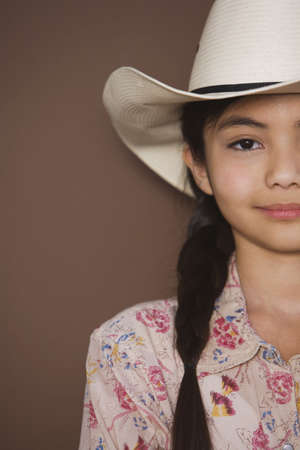 Studio shot of young girl wearing cowboy hatの写真素材