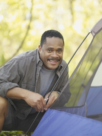African man putting up tentの写真素材