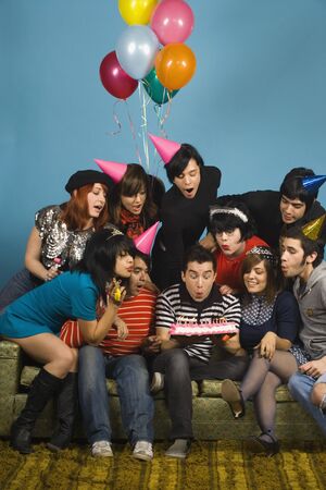 Group of young adults having birthday partyの写真素材