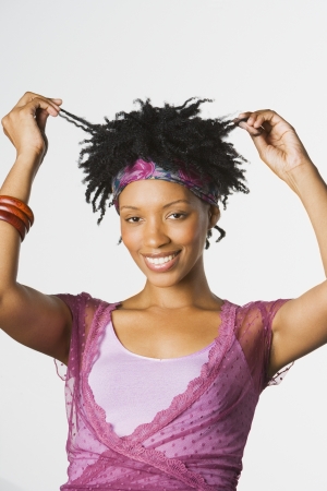 Studio shot of African woman pulling hairの写真素材