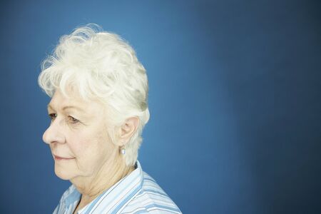 Studio shot of senior woman looking to sideの写真素材