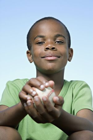 African boy holding baseballの写真素材