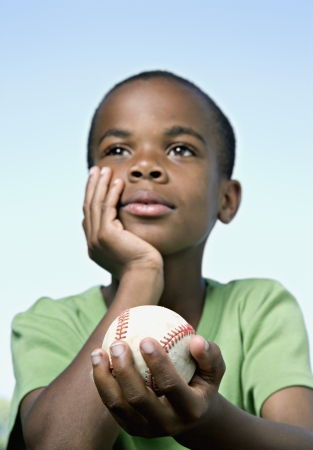 African boy holding baseballの写真素材