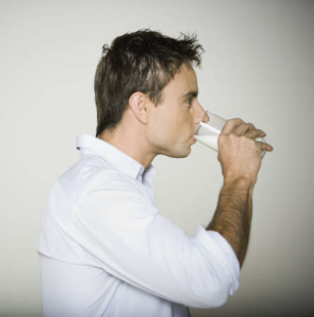 Profile of man drinking milkの写真素材